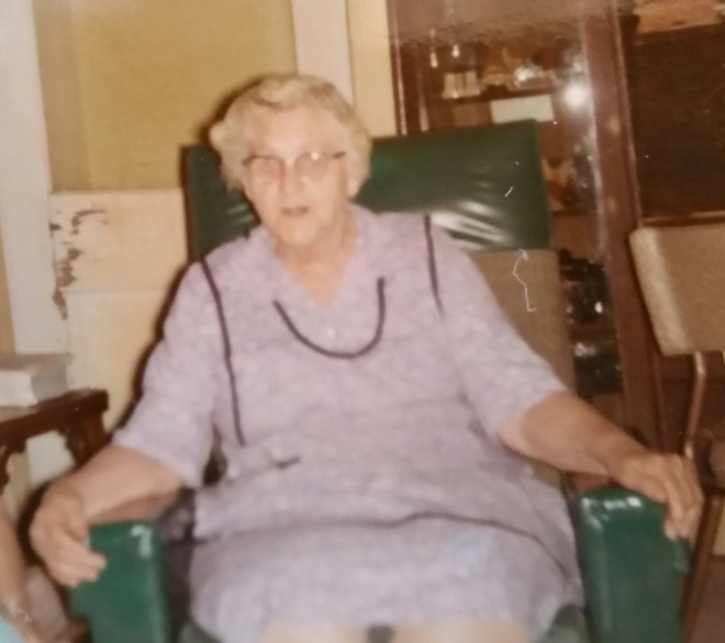 Grandma Nona wearing her apron, sitting in her recliner, maybe waiting to read a story...