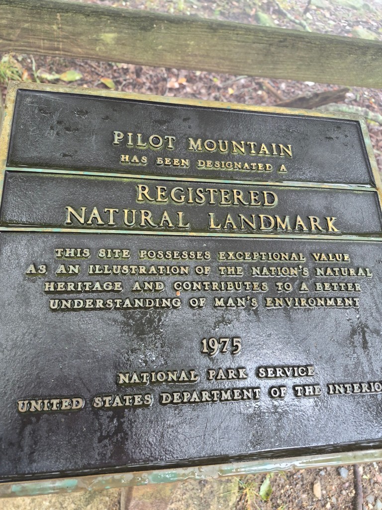 Plaque marking Pilot Mountain as a Registered Natural Landmark, highlighting its exceptional natural heritage value, established in 1975 by the National Park Service.